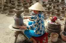 woman making clay pot