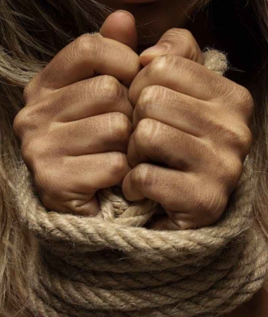 close up photo of woman with her hands tied with rope